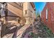 Narrow side yard featuring brick path and planting area at 537 N Logan St, Denver, CO 80203