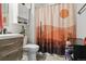 Cozy bathroom featuring a desert-themed shower curtain and a modern vanity with wood accents at 765 Mockingbird St, Brighton, CO 80601