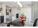 Dining area with glass table and pendant lighting is conveniently located next to the kitchen at 765 Mockingbird St, Brighton, CO 80601