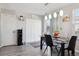 Bright dining area featuring a glass table, modern pendant lighting, and access to the laundry area at 765 Mockingbird St, Brighton, CO 80601