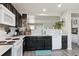 Modern kitchen with black cabinets, white countertops, stainless steel appliances, and a subway tile backsplash at 765 Mockingbird St, Brighton, CO 80601