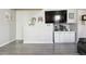 Cozy living room with built-in storage, gray wood floors, and decorative wall shelves at 765 Mockingbird St, Brighton, CO 80601