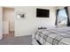 Spacious main bedroom with a large window, TV, and neutral decor at 765 Mockingbird St, Brighton, CO 80601
