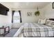 Comfortable main bedroom with a ceiling fan and window with natural light at 765 Mockingbird St, Brighton, CO 80601