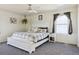 Cozy main bedroom with a comfortable bed, ceiling fan, and window with natural light at 765 Mockingbird St, Brighton, CO 80601
