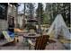 Backyard featuring a fire pit surrounded by Adirondack chairs, perfect for outdoor gatherings at 31332 Island Dr, Evergreen, CO 80439