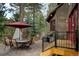 Outdoor patio space with dining set and grill, perfect for entertaining at 31332 Island Dr, Evergreen, CO 80439