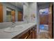 Bathroom with dual sinks and white countertops with modern wood cabinets at 31332 Island Dr, Evergreen, CO 80439