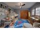 Childs bedroom with bunkbeds, space themed carpet, desk and ceiling fan at 31332 Island Dr, Evergreen, CO 80439