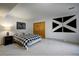 Neutral bedroom with a black and white checkered bedspread and dark wood accents at 31332 Island Dr, Evergreen, CO 80439