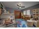 Childs bedroom with bunkbeds, space themed carpet, desk and ceiling fan at 31332 Island Dr, Evergreen, CO 80439