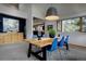 Dining area with a wooden table, blue chairs, and views of the living room at 31332 Island Dr, Evergreen, CO 80439