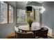 Bright dining area with large windows, wood floors, and a rustic round table with seating at 31332 Island Dr, Evergreen, CO 80439