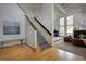 Elegant entryway with hardwood floors, staircase, and a glimpse into the living room with fireplace at 31332 Island Dr, Evergreen, CO 80439