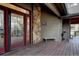 A beautiful deck area showcasing stone accents, wood flooring, and outdoor seating at 31332 Island Dr, Evergreen, CO 80439