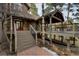 Inviting home exterior featuring stairs leading to a deck, complemented by stone accents at 31332 Island Dr, Evergreen, CO 80439