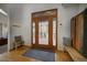 Inviting foyer featuring wood floors, a stylish rug, and an inviting view to the deck at 31332 Island Dr, Evergreen, CO 80439