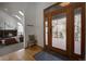 Bright foyer with hardwood floors and access to a cozy living room with a fireplace at 31332 Island Dr, Evergreen, CO 80439