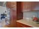 Well-organized kitchen featuring wood cabinets, stainless steel appliances, and stone countertops at 31332 Island Dr, Evergreen, CO 80439