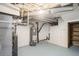 Unfinished basement with essential utilities, offering potential for customization and extra storage at 3242 N Albion St, Denver, CO 80207