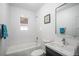 Spotless bathroom featuring tub, shower, window, and sleek vanity for a modern look at 3242 N Albion St, Denver, CO 80207