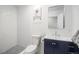 Modern bathroom with a navy vanity, rectangular mirror, and tiled shower and flooring at 3242 N Albion St, Denver, CO 80207