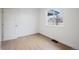 Bright bedroom featuring wood floors, white walls, and a window overlooking the neighborhood at 3242 N Albion St, Denver, CO 80207