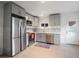 Modern kitchen with gray cabinets, stainless steel appliances, and tile backsplash, perfect for cooking at 3242 N Albion St, Denver, CO 80207