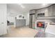 Open-concept kitchen and living area featuring stainless steel appliances and neutral color palette at 3242 N Albion St, Denver, CO 80207