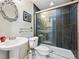Stylish bathroom featuring a glass shower, decorative mirror and pedestal sink at 1124 E 130Th Ave # C, Thornton, CO 80241