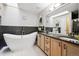 Bright bathroom featuring a freestanding tub, walk-in shower and granite vanity at 1124 E 130Th Ave # C, Thornton, CO 80241