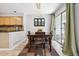 Cozy dining area with a chandelier, access to the patio, and adjacent kitchen create a warm, inviting space at 1124 E 130Th Ave # C, Thornton, CO 80241