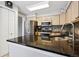 Modern kitchen featuring granite countertops, stainless steel appliances, and plenty of counter space for meal preparation at 1124 E 130Th Ave # C, Thornton, CO 80241