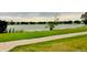 Picturesque lake view with paved walking path along the grassy shoreline at 1124 E 130Th Ave # C, Thornton, CO 80241
