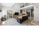 Bright living room features high ceilings, a cozy fireplace, and modern decor with wood-look floors at 1124 E 130Th Ave # C, Thornton, CO 80241