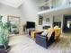 Bright living room featuring high ceilings, a fireplace, and hardwood floors at 1124 E 130Th Ave # C, Thornton, CO 80241