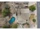 An aerial view of home with a pool, spacious backyard and deck, surrounded by mature trees at 2492 S Yarrow St, Lakewood, CO 80227