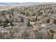 Aerial view of a neighborhood showcasing the location of the featured home amid lush greenery and mountain views at 2492 S Yarrow St, Lakewood, CO 80227