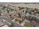 Aerial view of home with fenced-in yard nestled in a residential neighborhood surrounded by mature trees at 2492 S Yarrow St, Lakewood, CO 80227