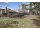 Expansive backyard featuring a deck, partial lawn, mature trees, and an enclosed swimming pool area at 2492 S Yarrow St, Lakewood, CO 80227