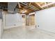 Unfinished basement area, with exposed beams and concrete floor, offers potential for customization at 2492 S Yarrow St, Lakewood, CO 80227