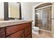 A standard bathroom with a sink and cabinet and a shower with glass door at 2492 S Yarrow St, Lakewood, CO 80227