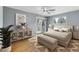 Bright bedroom with hardwood floors, ceiling fan, slider door to deck, and natural light at 2492 S Yarrow St, Lakewood, CO 80227
