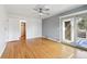 Large bedroom featuring hardwood floors, ceiling fan, closet, and access to outdoor deck at 2492 S Yarrow St, Lakewood, CO 80227