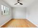 Bright bedroom features hardwood floors, a modern ceiling fan, and a window for natural light at 2492 S Yarrow St, Lakewood, CO 80227