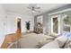 Bright bedroom with hardwood floors, ceiling fan, closet, and a slider door to the deck at 2492 S Yarrow St, Lakewood, CO 80227
