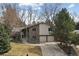 Charming two-story brick home with a well-manicured lawn and a two-car garage at 2492 S Yarrow St, Lakewood, CO 80227