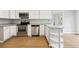 Well-equipped kitchen featuring modern appliances, white cabinets, and efficient layout at 2492 S Yarrow St, Lakewood, CO 80227