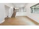 Open concept living room with a kitchen upstairs and hardwood floors throughout at 2492 S Yarrow St, Lakewood, CO 80227