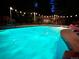 Backyard pool at night, illuminated by string lights, creating a relaxing and inviting atmosphere at 2492 S Yarrow St, Lakewood, CO 80227